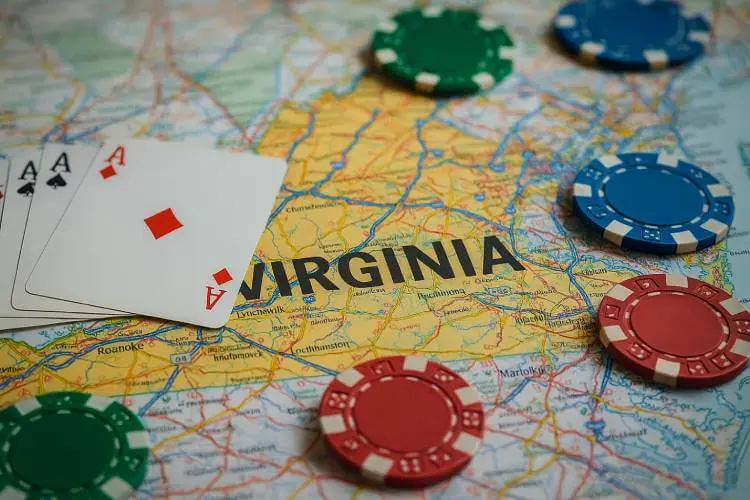 Virginia state map with casino chips and playing cards placed across key cities, representing lawmakers’ discussions on creating a Virginia Gaming Commission and regulating casinos and online gambling.