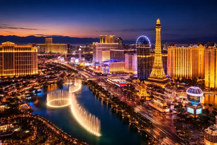 Las Vegas Strip skyline at dusk with casino resorts and traffic along the Strip.